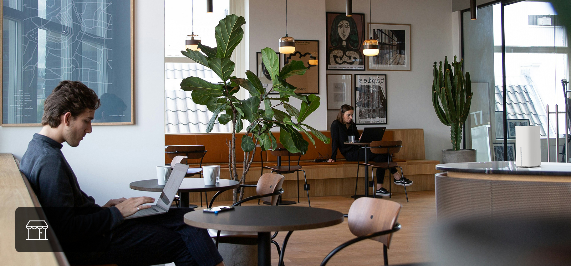 Man working on laptop in a store