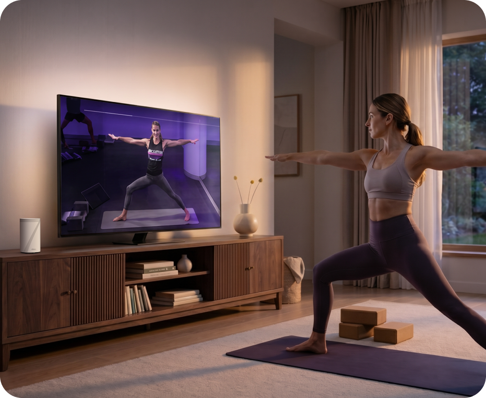 A fit woman exercising with a tv instructor