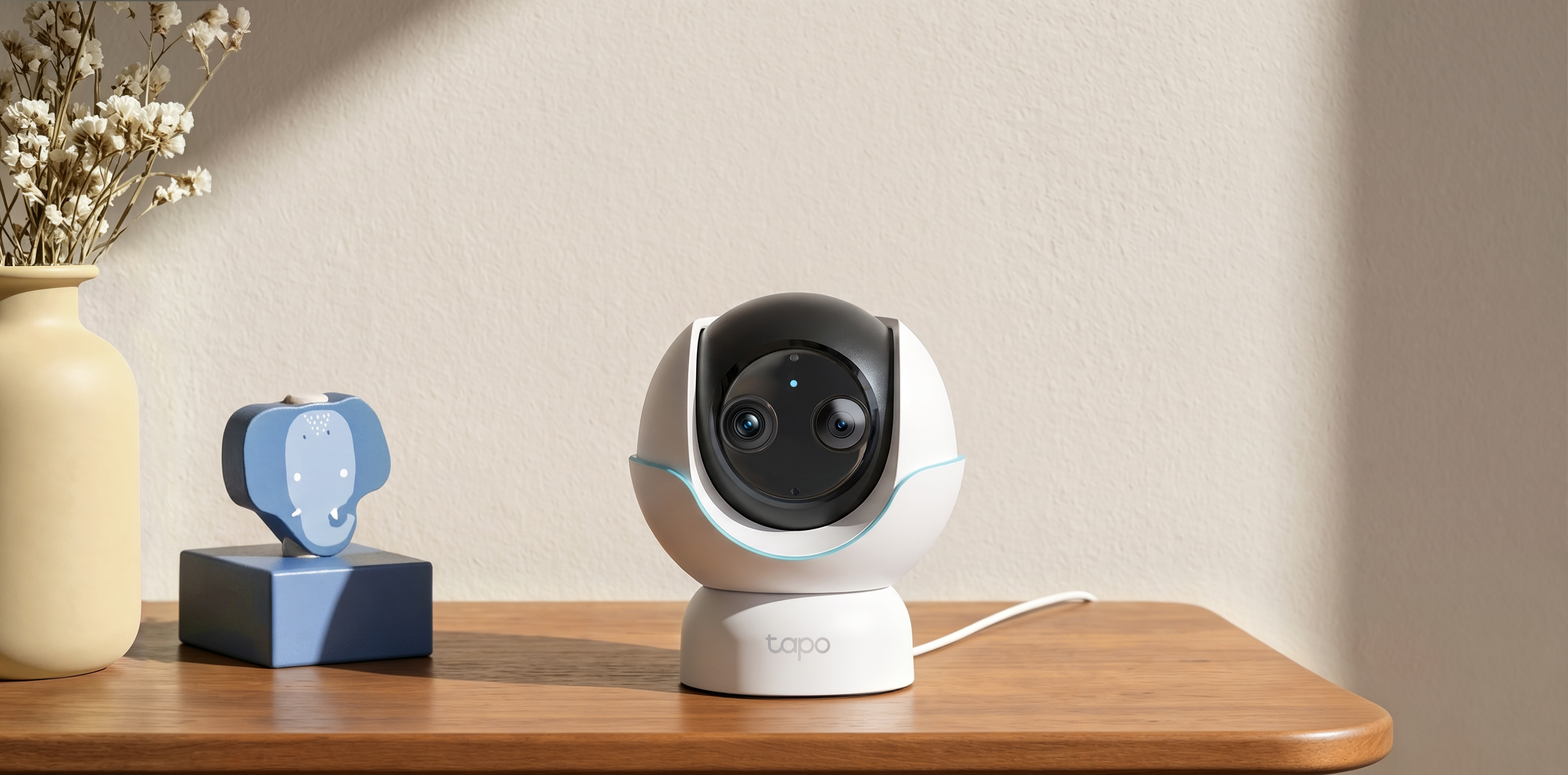 Tapo C840 dual-lens camera on a nursery table.