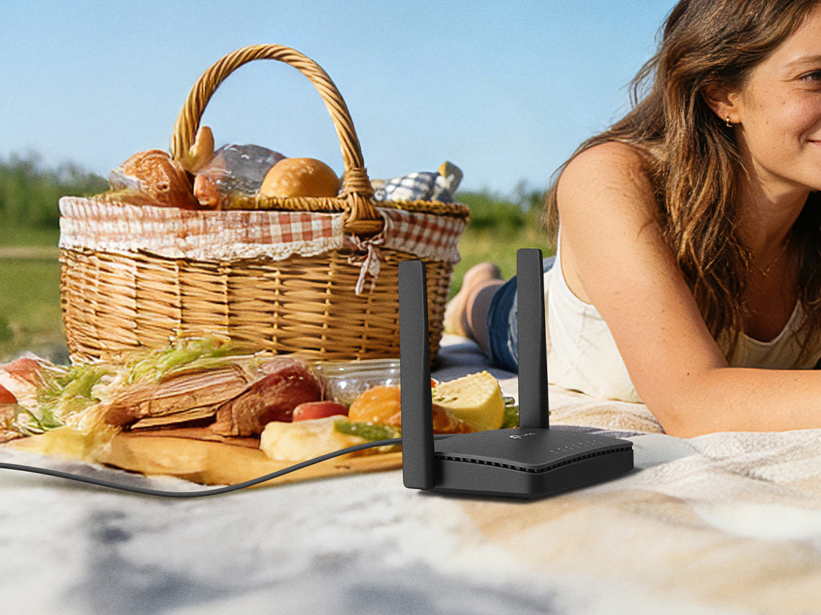 Girl lying on a picnic blanket with a router next to her