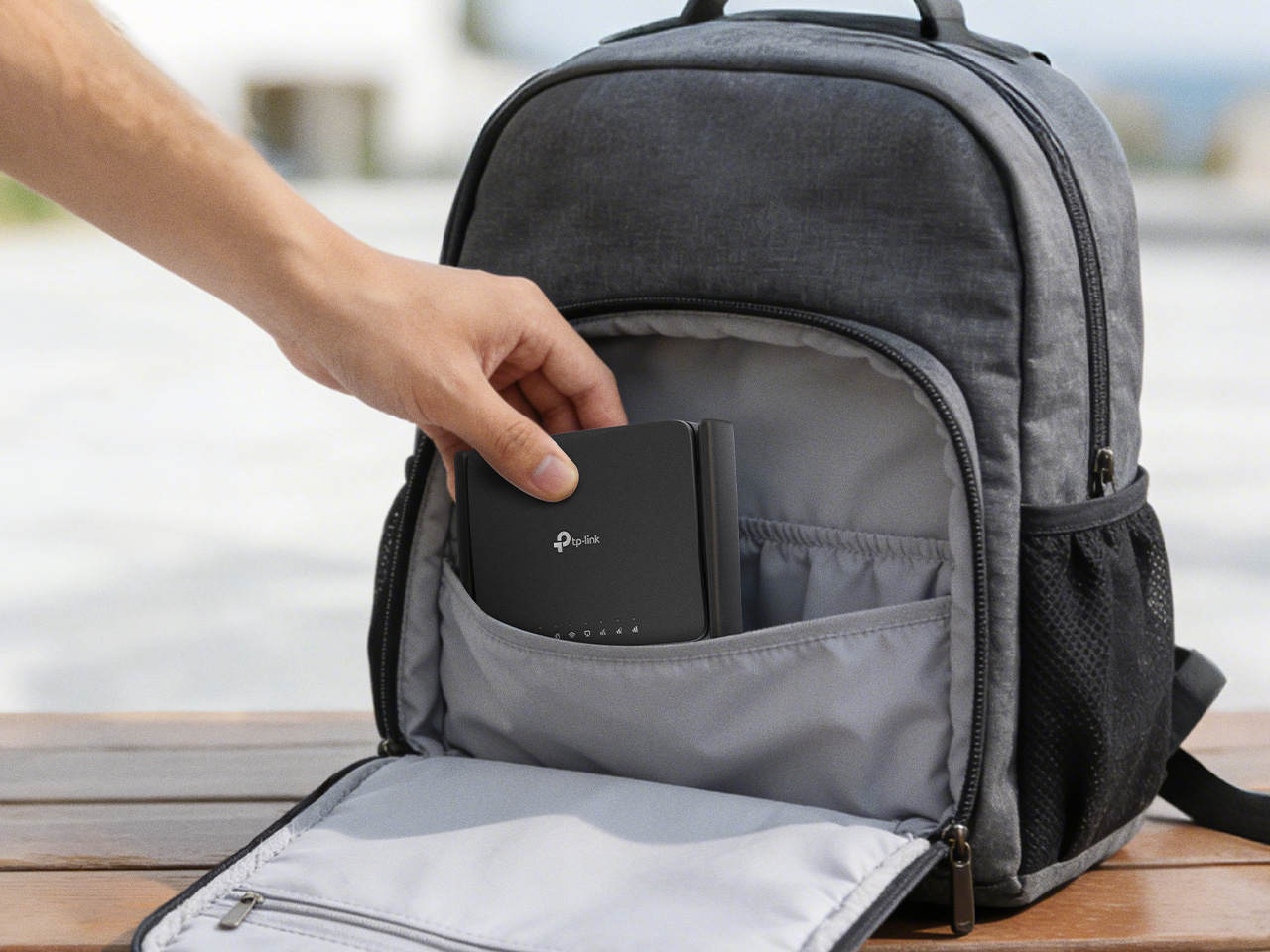 Hand placing router inside a backpack